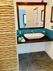 a bathroom with a sink and a mirror at Mountain seaview Cabanas in Tangalle +164 photos