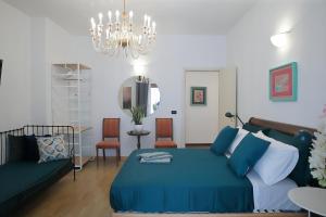 a bedroom with a bed and a couch and a chandelier at L.T. Savoia Palace & Cavour C.L. in Bari