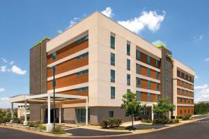 a large office building with a parking lot at Home2 Suites by Hilton Austin Round Rock in Round Rock
