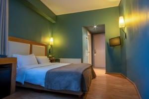 Postel nebo postele na pokoji v ubytování Olympic Hotel