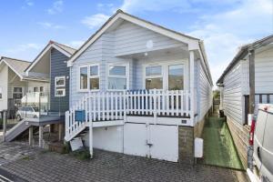 a small blue house with a white porch at 28 Marsh Road in Gurnard