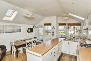 a kitchen and dining room with a table and chairs at 28 Marsh Road in Gurnard