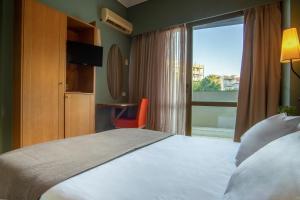 Postel nebo postele na pokoji v ubytování Olympic Hotel