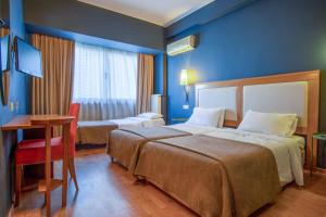 Postel nebo postele na pokoji v ubytování Olympic Hotel