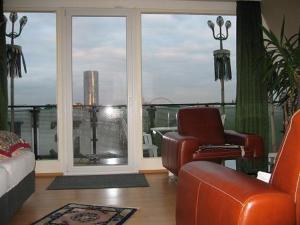 a living room with a view of a balcony at Hotel Römerhafen in Cologne