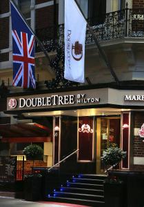 a building with two flags in front of it at DoubleTree by Hilton Hotel London - Marble Arch in London