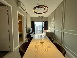 a dining room with a table with wine glasses on it at AXON Suites Bukit Bintang By Sky Pool in Kuala Lumpur