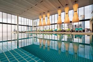 a swimming pool in a building with glass windows at Crown Metropol Melbourne in Melbourne