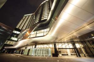 a large building with a lot of windows at night at Crown Metropol Melbourne in Melbourne