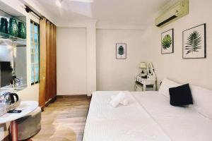 a small room with a white bed and a desk at Anh Thien Sai Gon Central Hotel - District 1 in Ho Chi Minh City