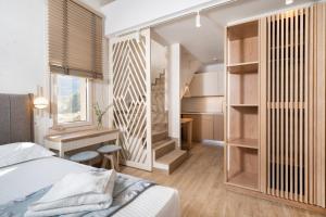 a bedroom with a bed and a desk in a room at ILIORAMA LUXURY SUITES in Skala Potamias