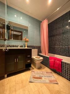 a bathroom with a toilet and a sink and a mirror at By La Rambla Rooms in Barcelona