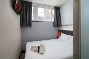 a bedroom with a white bed and a window at easyHotel Ipswich in Ipswich