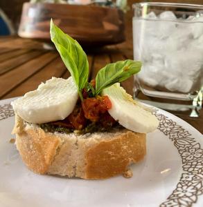 a piece of bread with cheese and greens on it at Wildwood Heart Farm in Boomer