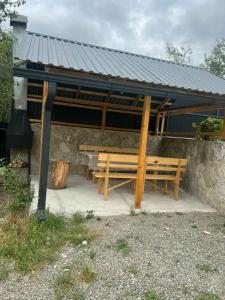 a pavilion with a picnic table and a bench at Cozy Cottage Dilijan Arm in Dilijan