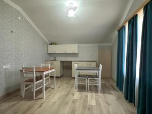 a kitchen with a table and chairs in a room at Happy House in Kutaisi