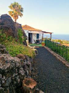 a house on a hill next to the ocean at Casita Canaria con Vista in Breña Baja