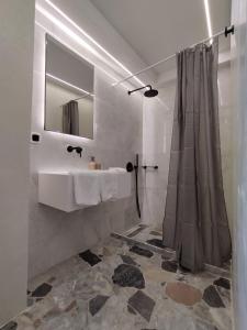 a bathroom with a sink and a mirror at Manolioudis Villas in Bali