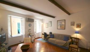 a living room with a couch and a table at La casa nel cuore di Camogli in Camogli