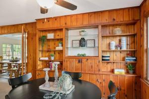 a dining room with a table and wooden walls at HOT TUB - Grand Haven/Spring Lake Waterfront Home in Spring Lake