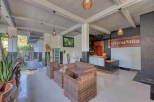 a restaurant with brown wicker chairs and a bar at Dyou Villa in Nusa Penida