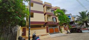 a building with a motorcycle parked in front of it at Magnolia Villa Luxury 3 Bedroom Apartments in Visakhapatnam