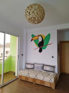 a painting of a bird on a wall at Dar Mouja, eco-friendly home in Imsouane