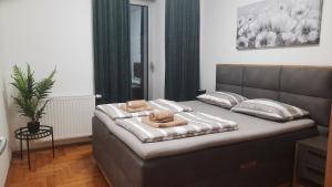 a bedroom with a bed with two towels on it at Apartman Tena in Vukovar