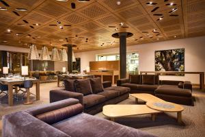 a large living room with couches and a table at The Omnia in Zermatt