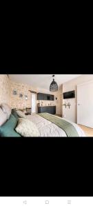 a bedroom with a large bed and a kitchen at IMHOST - Amazing architect studio Père Lachaise in Paris