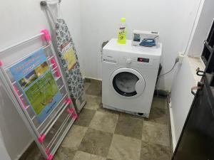 a small bathroom with a washing machine in a room at Holiday home in Lamin