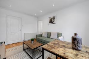 a living room with a couch and a table at The Old Street Apartment in London