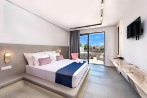 a bedroom with a large bed and a tv at Madison Boutique, Faliraki in Faliraki +75 photos