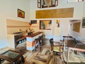 a kitchen with a table and chairs and a refrigerator at Villa villa in Villa de Leyva