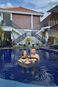 a man and a woman in a swimming pool at Dyou Villa in Nusa Penida