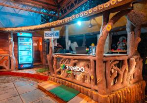 a bar made out of logs in a restaurant at Treebo Trend Rock Valley in Ponda