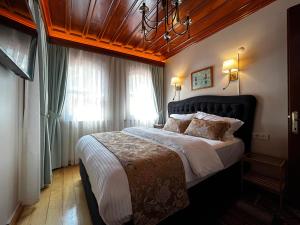a bedroom with a large bed and a chandelier at Lily Mansion in Istanbul