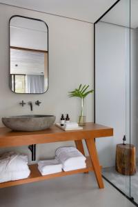 a bathroom with a sink and a mirror at Fuso Concept Hotel in Florianópolis