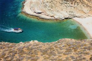 an aerial view of a boat in a body of water at Rustic Stone House in the Heart of Folegandros in Áno Meriá