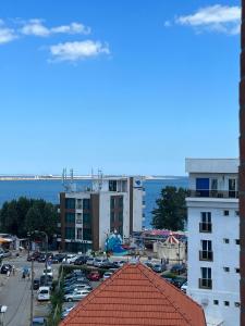a view of a parking lot with cars and buildings at Apartaments PopDan Residence by the Sea in Eforie Nord