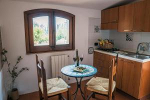a kitchen with a table and chairs and a sink at villa palmi in Agrigento