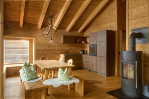 a kitchen with a table and a stove in a room at DESIGN-CHALETS by Pferd auf Wolke NEU in Gaschurn