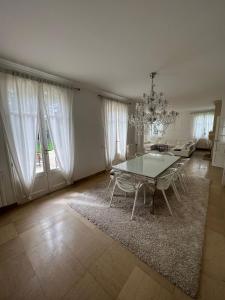 a living room with a table and chairs in it at Charming Barbizon Villa in Barbizon