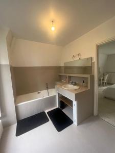 a bathroom with a sink and a bath tub at Charming Barbizon Villa in Barbizon