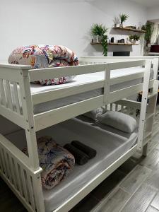 a white bunk bed with pillows on it at Meu Loft Barra Nova 3 in Saquarema