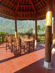 a table and chairs under a pavilion with a view at Lee's Charm Homestay in Sa Pa