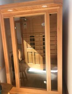 a wooden cabinet with a reflection of a staircase in it at Evenly Balanced in Killarney