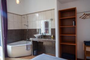 a bathroom with a tub and a sink and a bath tub at Private Room & Private Bathroom - Historic Center in Béziers