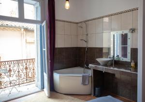 a bathroom with a tub and a sink at Private Room & Private Bathroom - Historic Center in Béziers