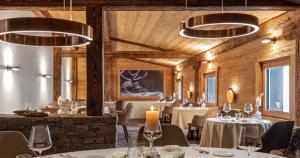 a restaurant with white tables and chairs and lights at Kapitel 7 Boutique-Hotel in Raron